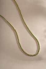 Detail of bezel-set round green stones on emerald tennis necklace, view 3