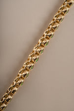 Detail of bezel-set round green stones on emerald tennis necklace, view 7