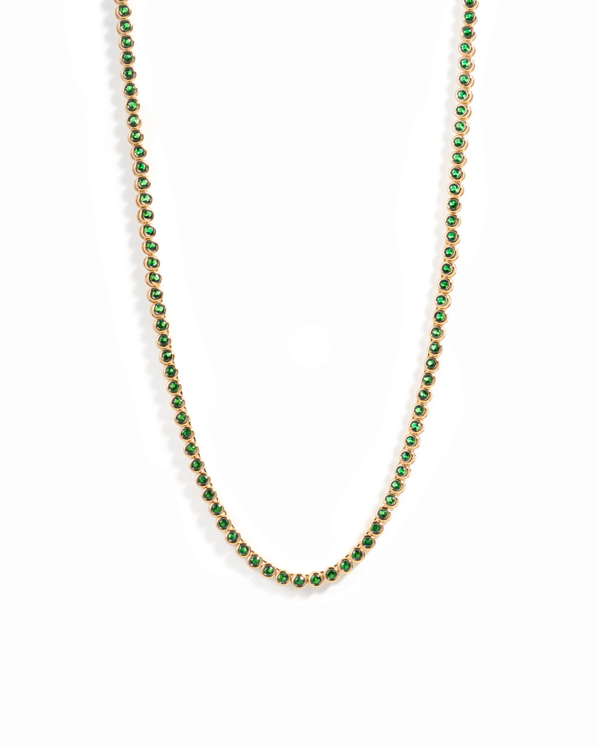 Gold plated round emerald tennis necklace on white background