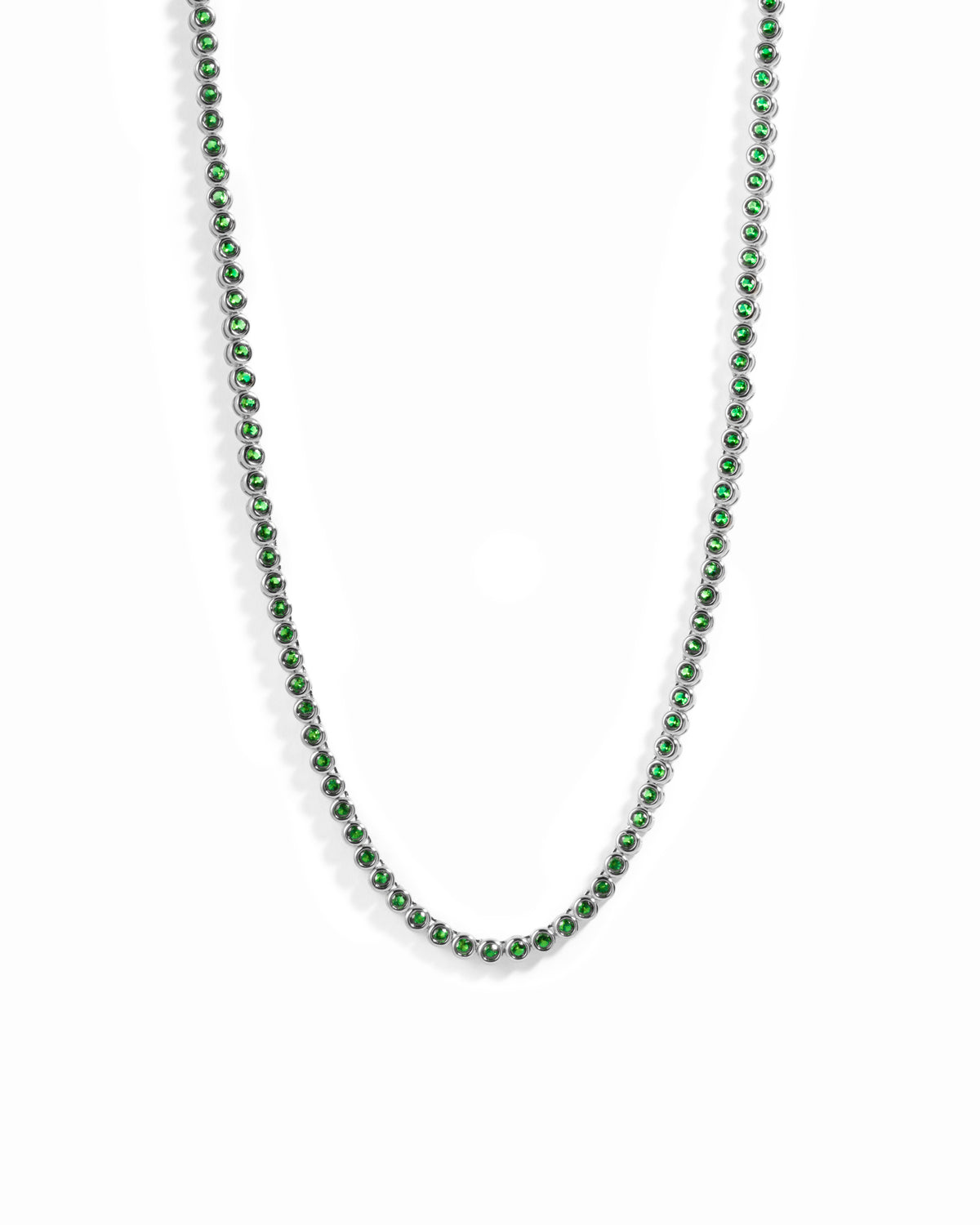 Rhodium plated silver round emerald tennis necklace on white background
