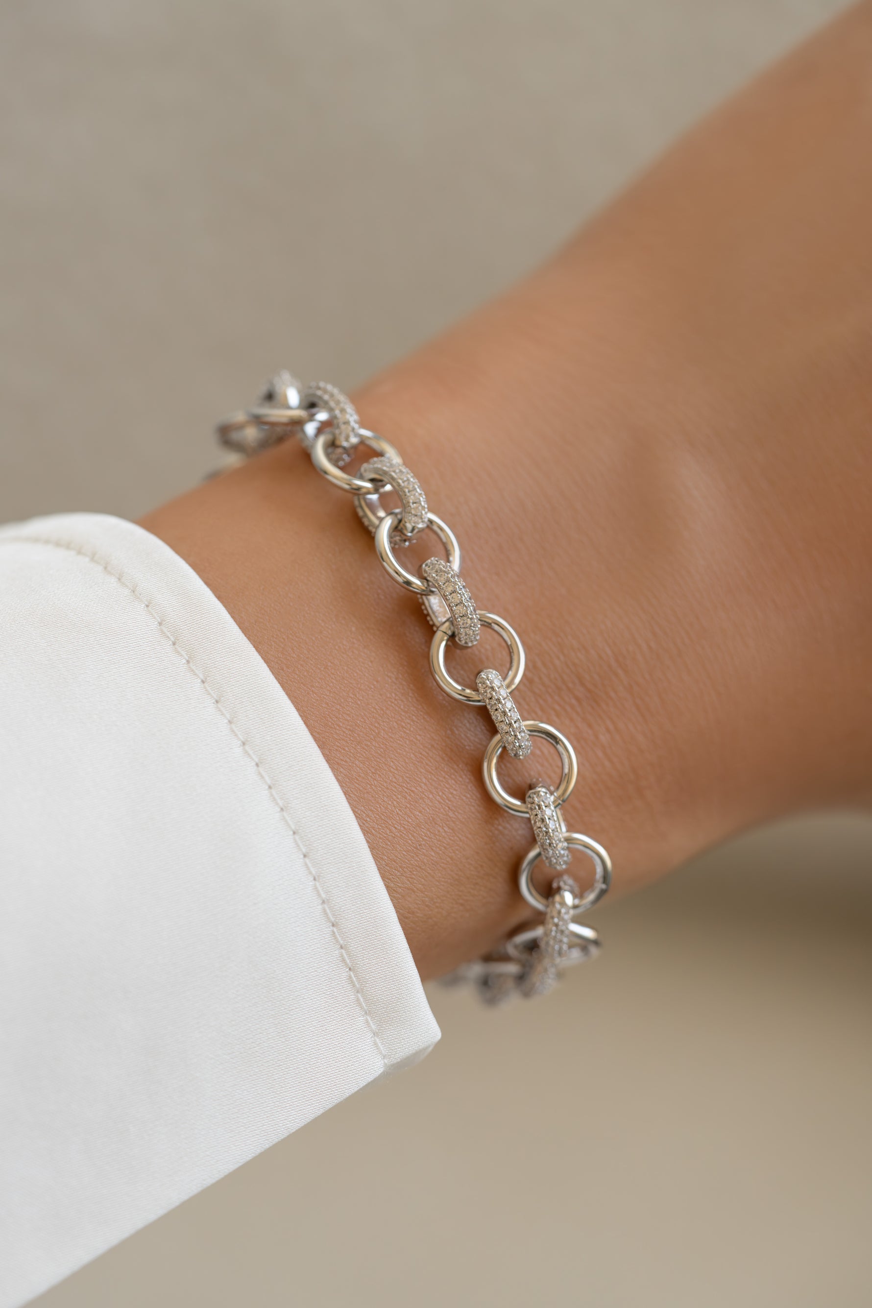 Silver Sami Jewels round pave link bracelet featuring interconnected circular chains on a model's wrist.