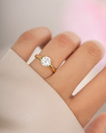 Gold round solitaire ring by Sami Jewels featuring a single sparkling gemstone on a sleek band.