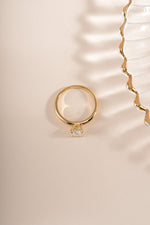 Gold round solitaire ring by Sami Jewels, top view showcasing the single sparkling gemstone on the elegant band.