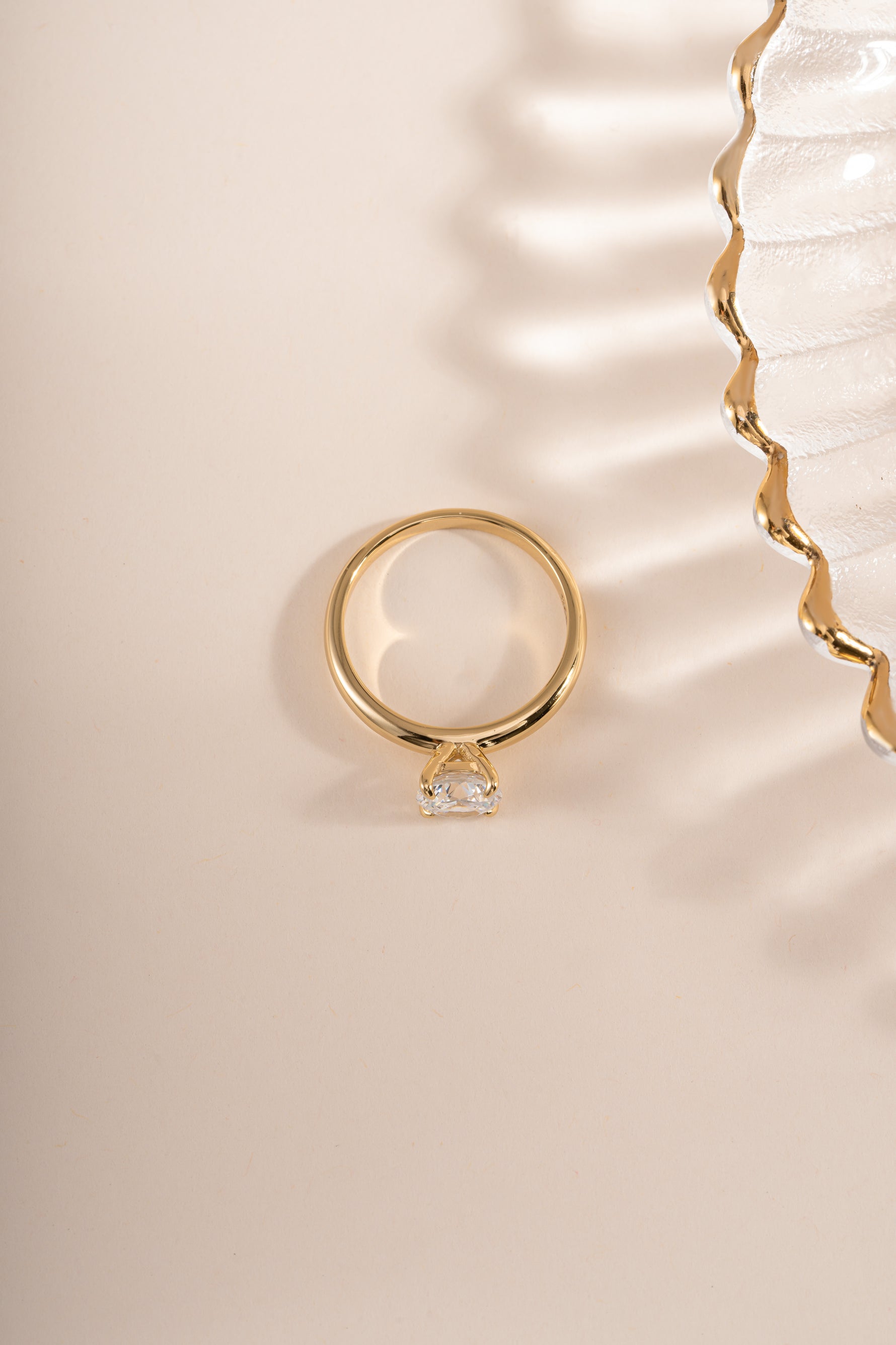 Gold round solitaire ring by Sami Jewels, top view showcasing the single sparkling gemstone on the elegant band.