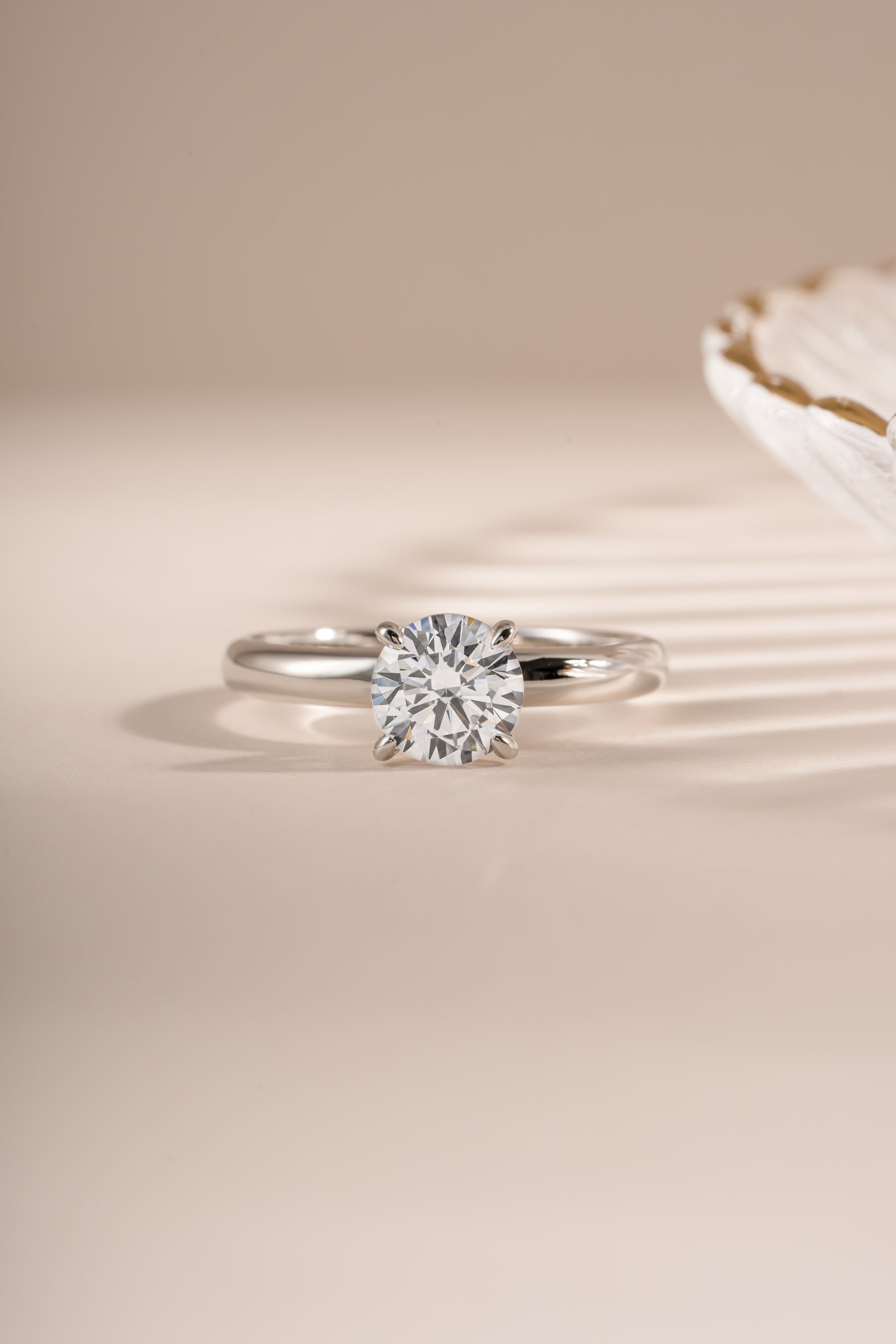 Close-up of Sami Jewels sterling silver round solitaire ring showcasing a single sparkling gemstone.