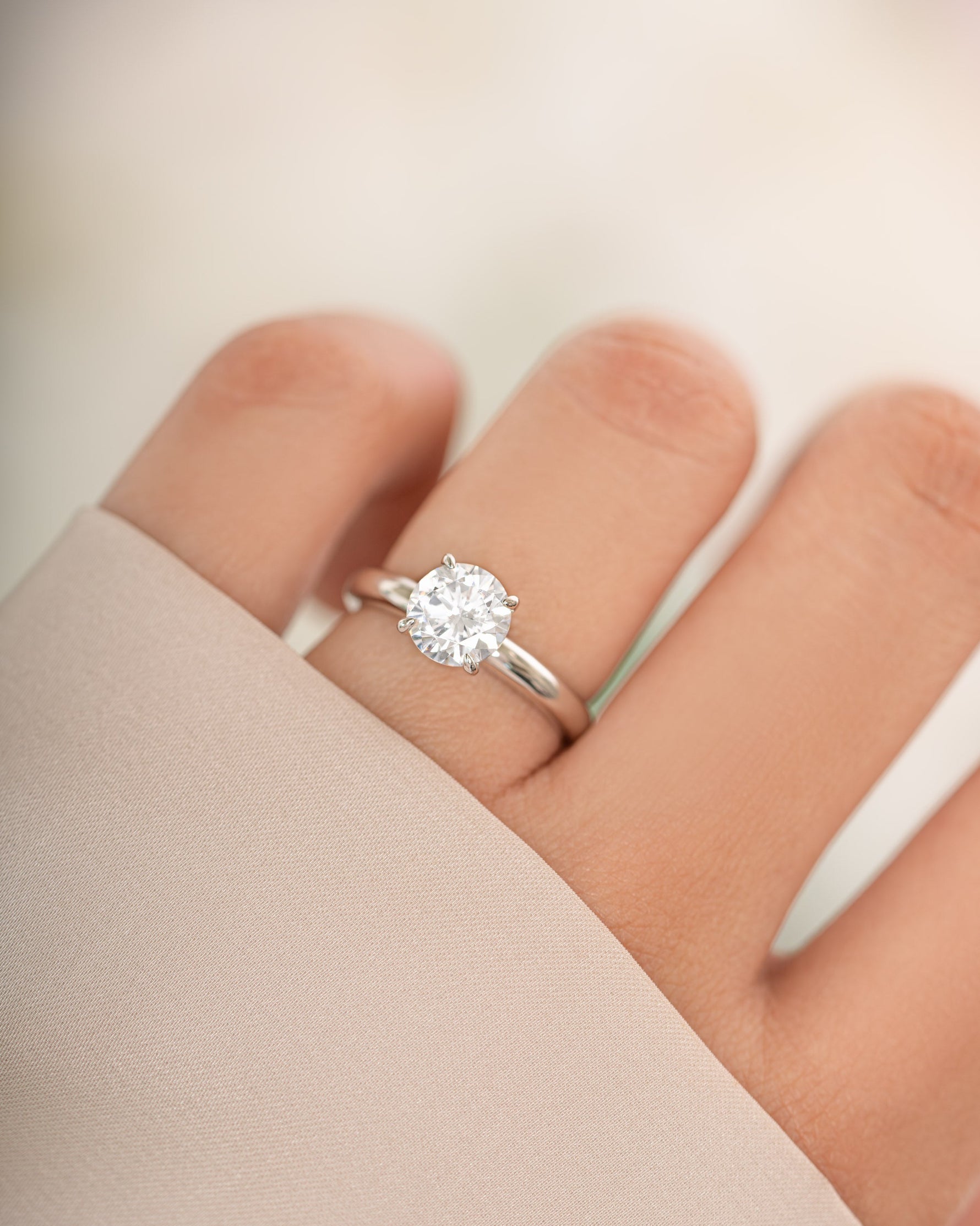 Sterling silver round solitaire ring from Sami Jewels featuring a single central gemstone on a sleek band.