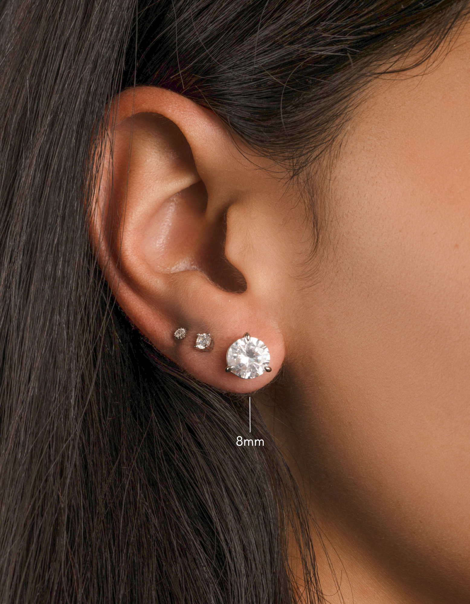 round solitaire stud earrings in sterling silver in a 8mm on models ear