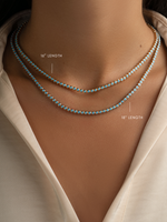 Stacked round turquoise tennis necklaces by Sami Jewels featuring gold chain links and vibrant turquoise stones.