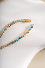 Turquoise bezel tennis necklace by Sami Jewels featuring round turquoise stones, gold box clasp, elegant jewelry for women.