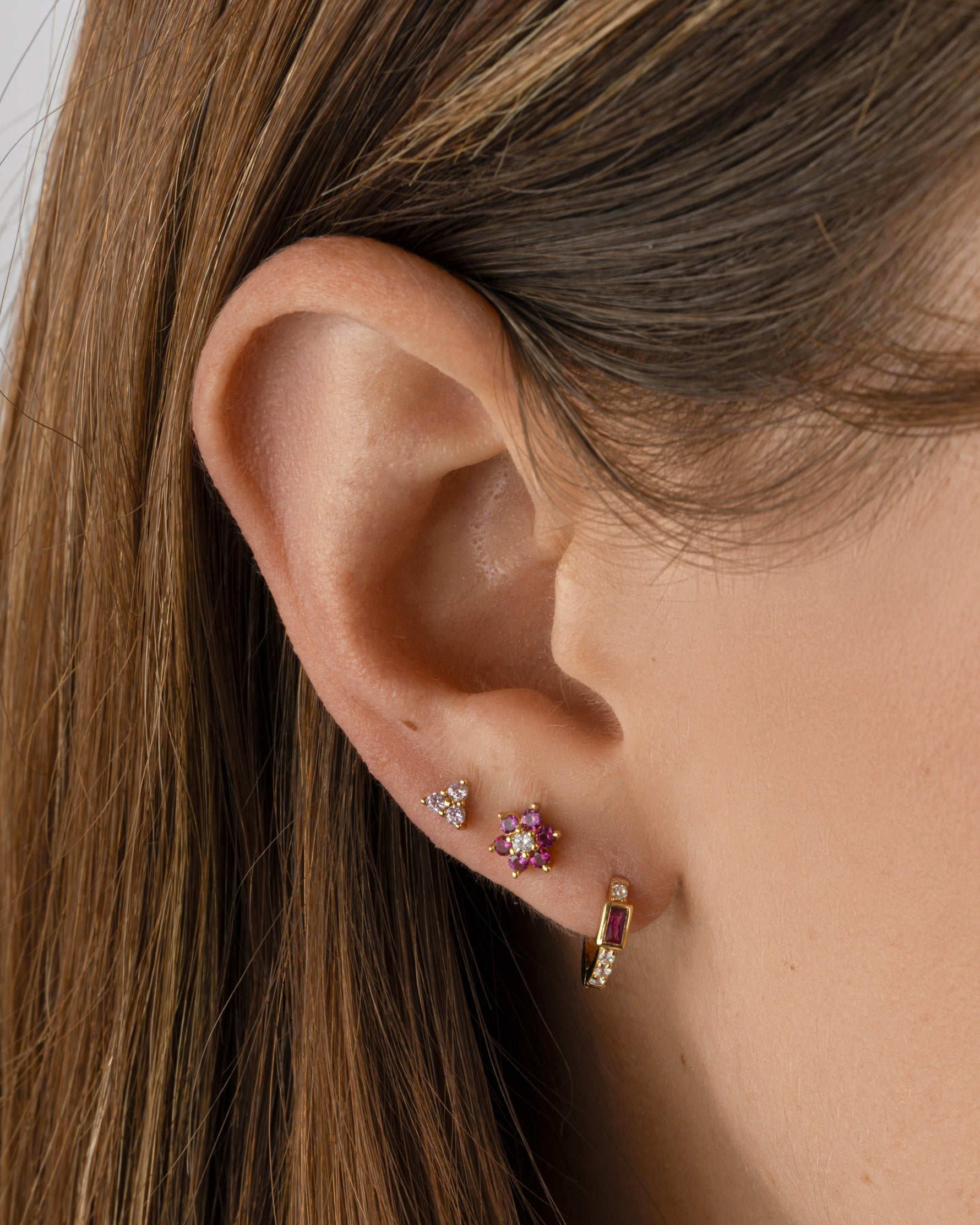 Gold Sami Jewels Ruby Baguette Huggie Earrings featuring sparkling ruby baguette stones in a stylish hoop design