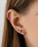 Sami Jewels Ruby Baguette Huggie Earrings in sterling silver featuring vibrant red rectangular rubies and sleek hoop design.