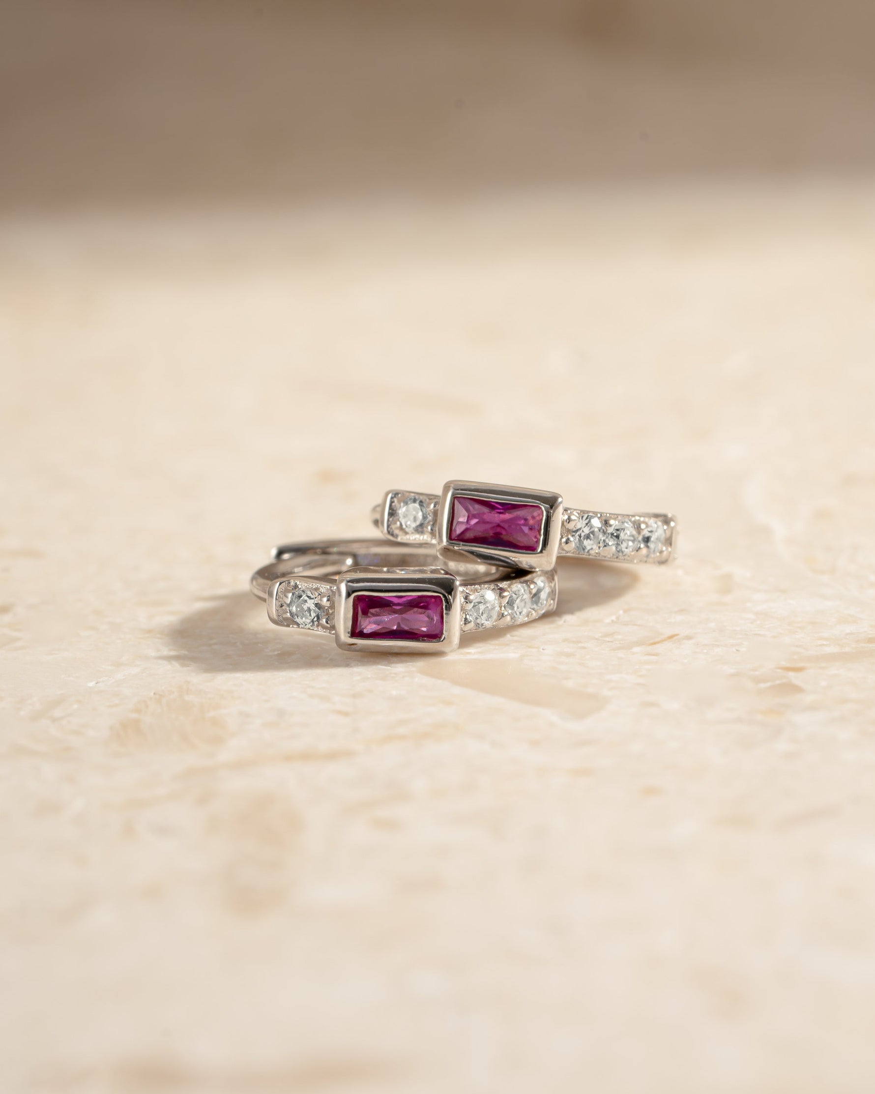 Sterling silver Ruby Baguette Huggie Earrings with side view, showcasing sparkling red gemstones and sleek hoop design.