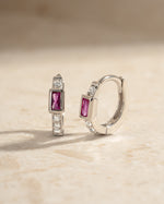 Sterling silver Ruby Baguette Huggie Earrings featuring vibrant red gemstones and a sleek, modern hoop design.