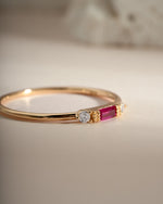 Close-up of Sami Jewels Ruby Baguette Ring featuring a gold band and a vibrant ruby baguette gemstone.