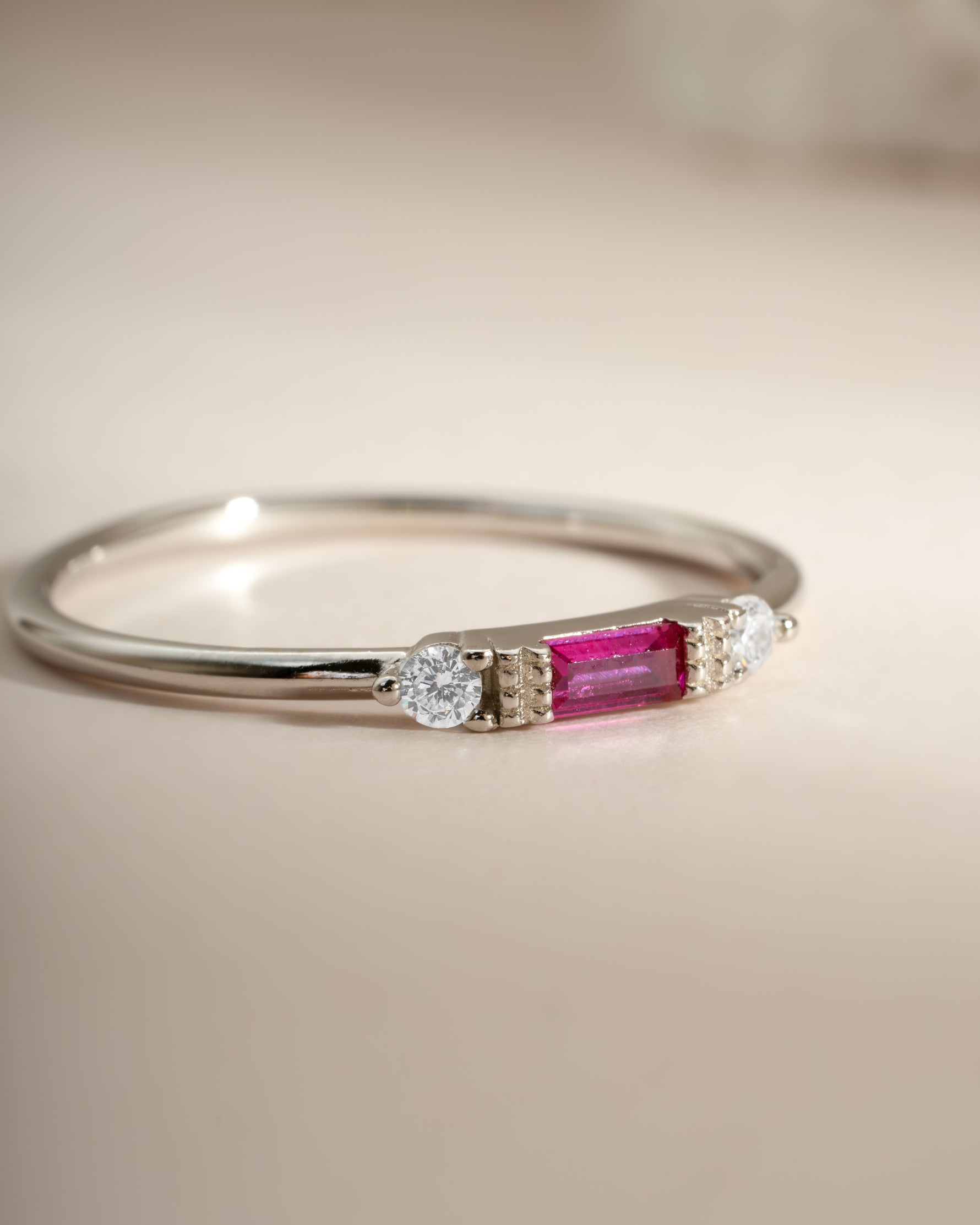 Sami Jewels Ruby Baguette Ring in sterling silver, angled view showcasing the elegant ruby baguette gemstone and sleek band design.