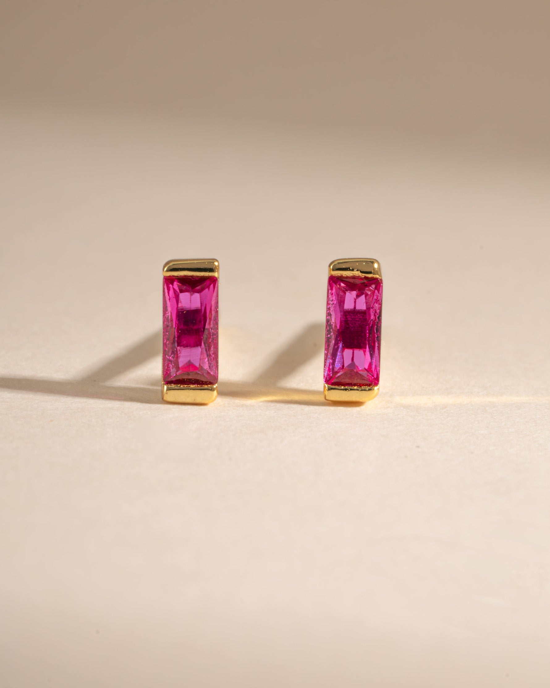 Gold Ruby Baguette Stud Earrings by Sami Jewels, front view showing rectangular red rubies set in elegant gold studs.