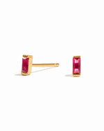 ruby baguette stud earrings in gold on a white background