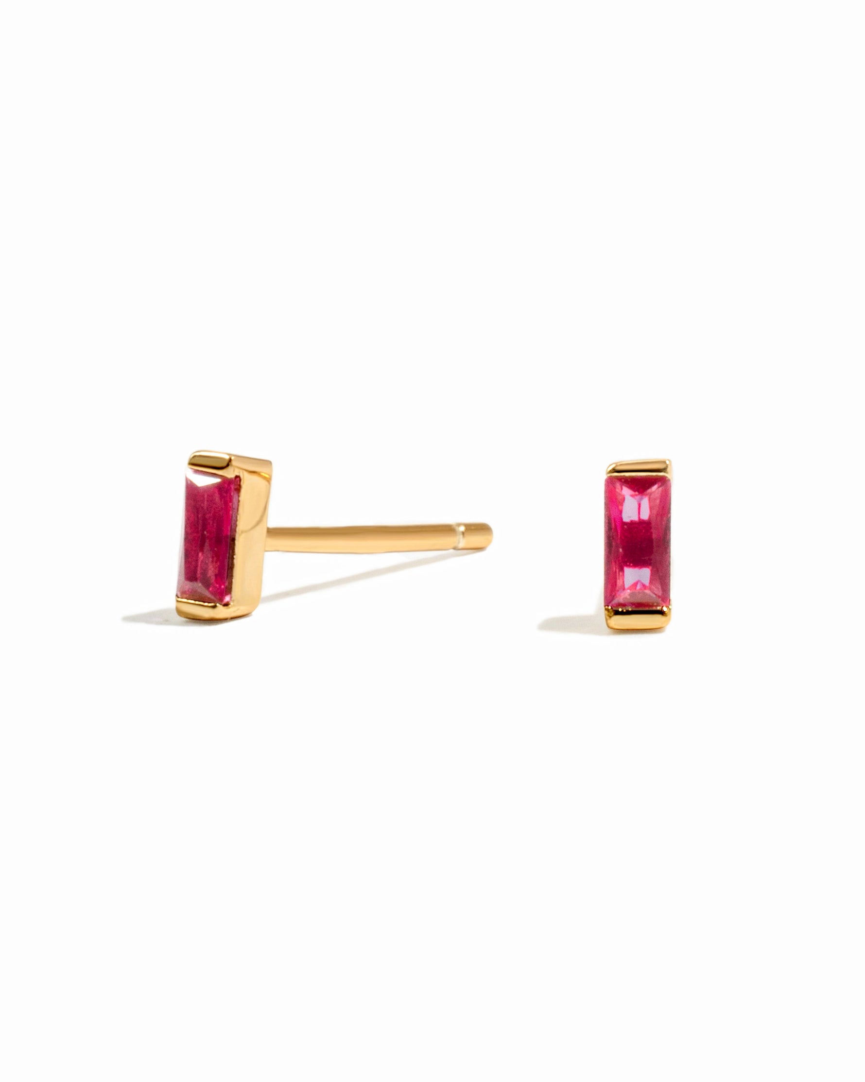 ruby baguette stud earrings in gold on a white background