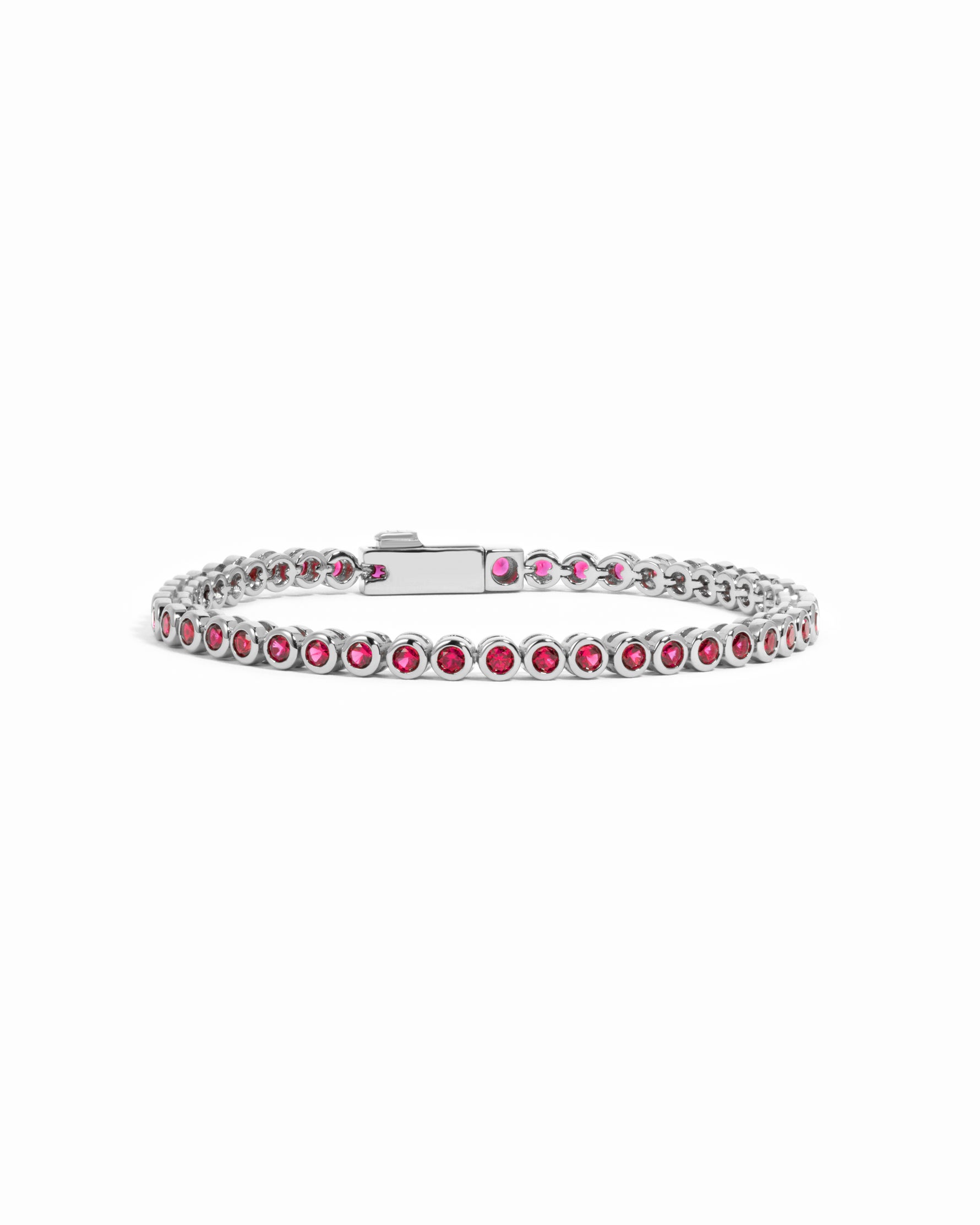 Silver Ruby Bezel Tennis Bracelet by Sami Jewels, featuring sparkling rubies set in a sleek bezel design on a white background.