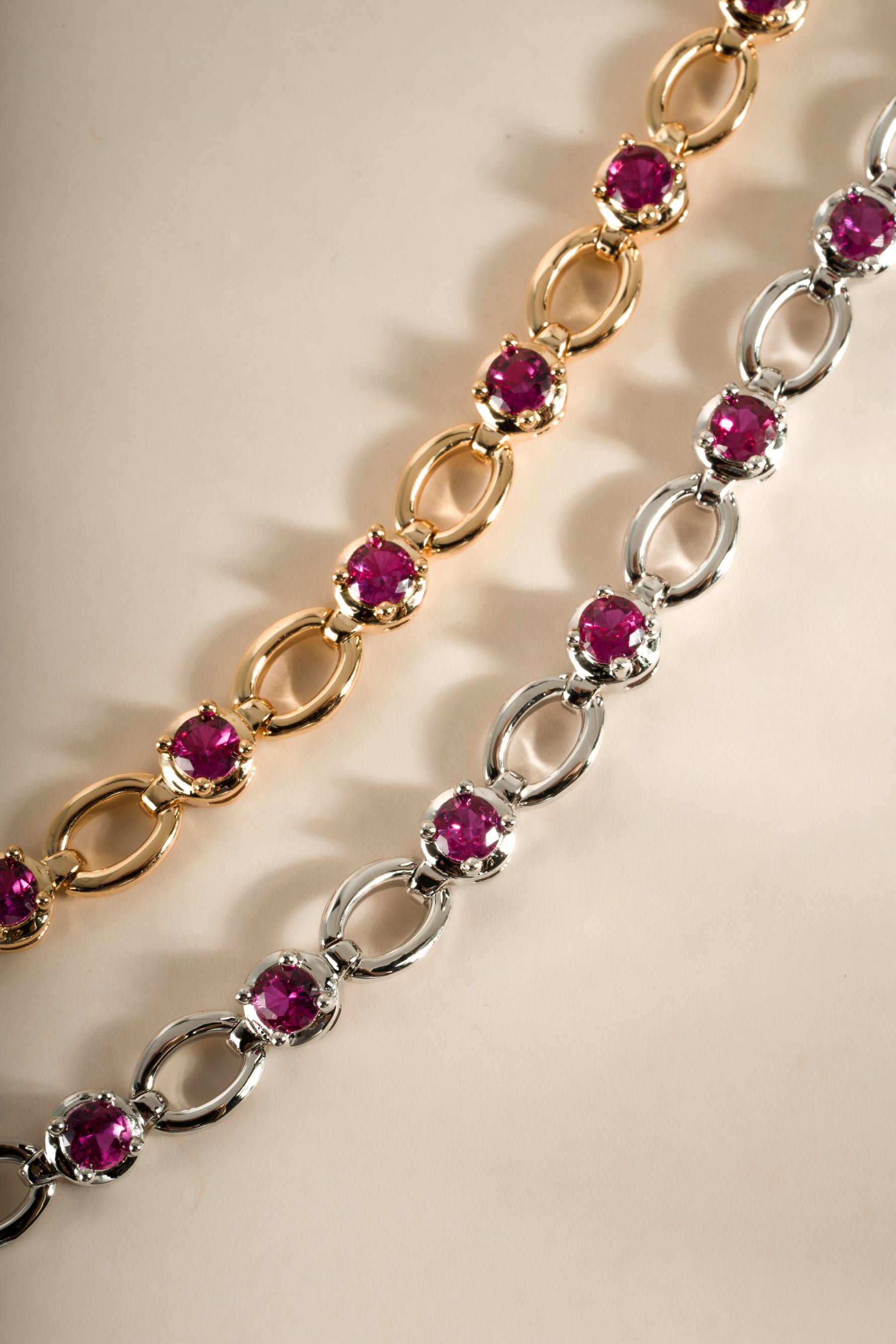 Gold and rhodium-finished Ruby Lilly Tennis Bracelet by Sami Jewels featuring vibrant red rubies and elegant design.