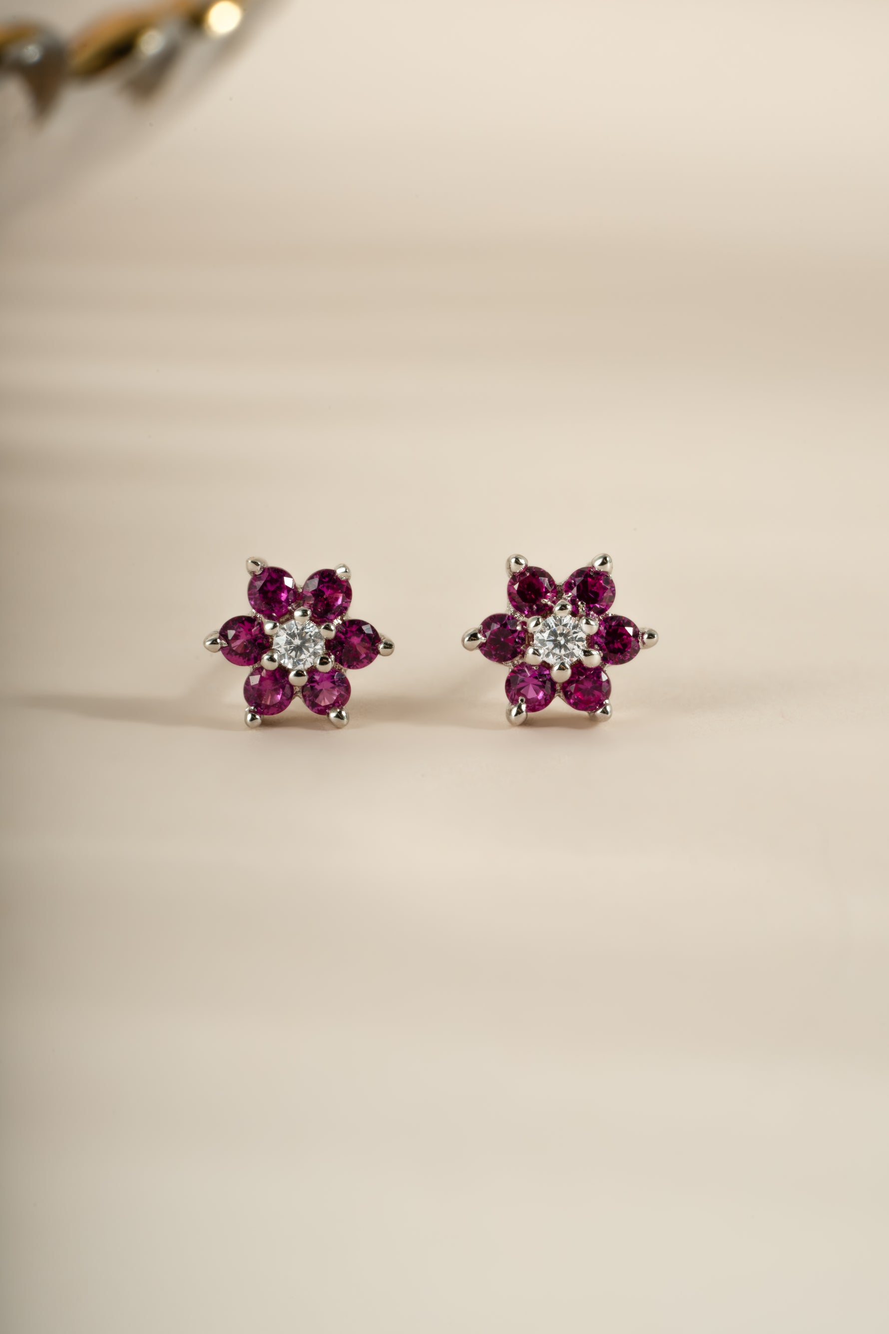 Sterling silver Ruby Flower Stud Earrings with CZ center stone by Sami Jewels, front view showing detailed floral design and sparkling accents.