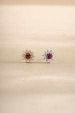 Silver and gold ruby dainty flower earrings by Sami Jewels featuring small floral stud design.