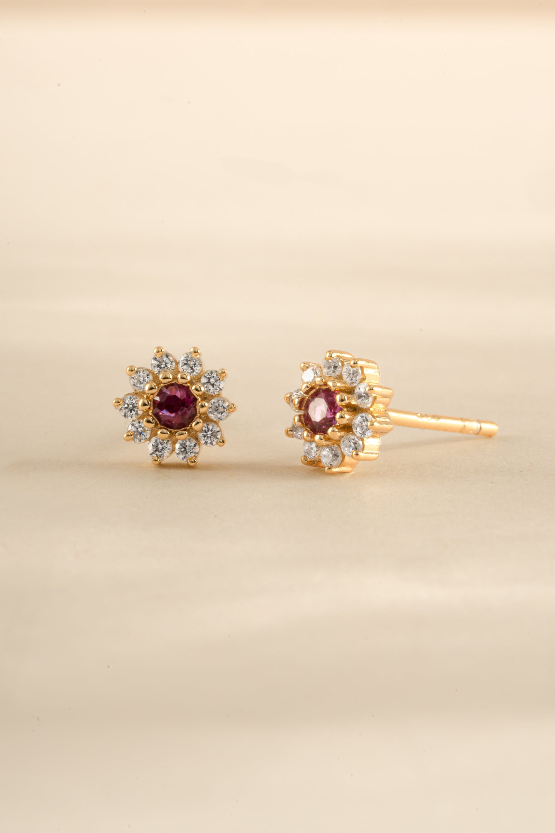 Gold Ruby Dainty Flower Stud Earrings by Sami Jewels, featuring small floral design with vibrant red gemstones.