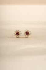 Gold Ruby Dainty Flower Stud Earrings by Sami Jewels, featuring small floral design with vibrant ruby gemstones.
