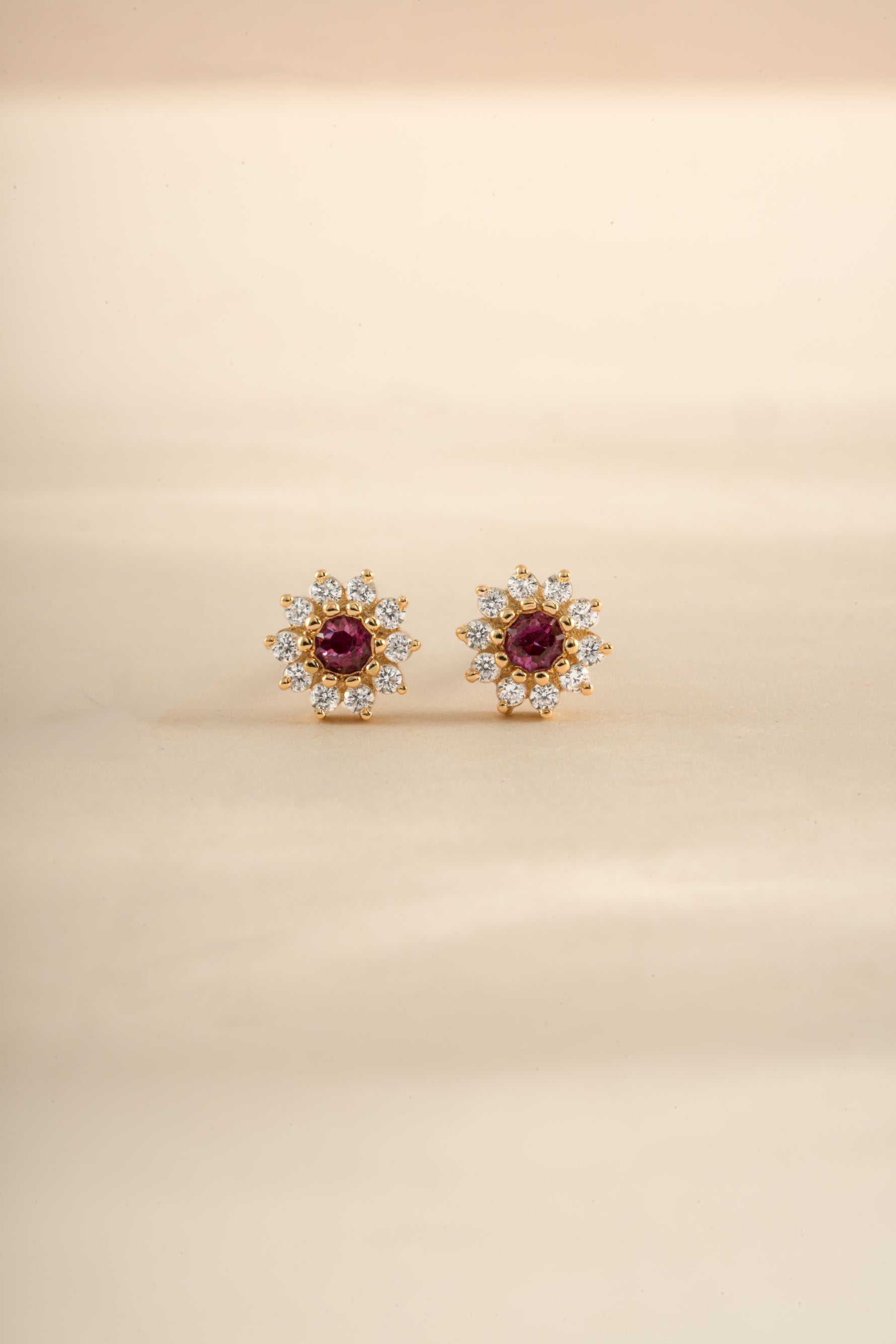 Gold Ruby Dainty Flower Stud Earrings by Sami Jewels, featuring small floral design with vibrant ruby gemstones.