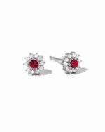 Sterling silver Ruby Dainty Flower Stud Earrings by Sami Jewels with small red ruby flower design on a white background
