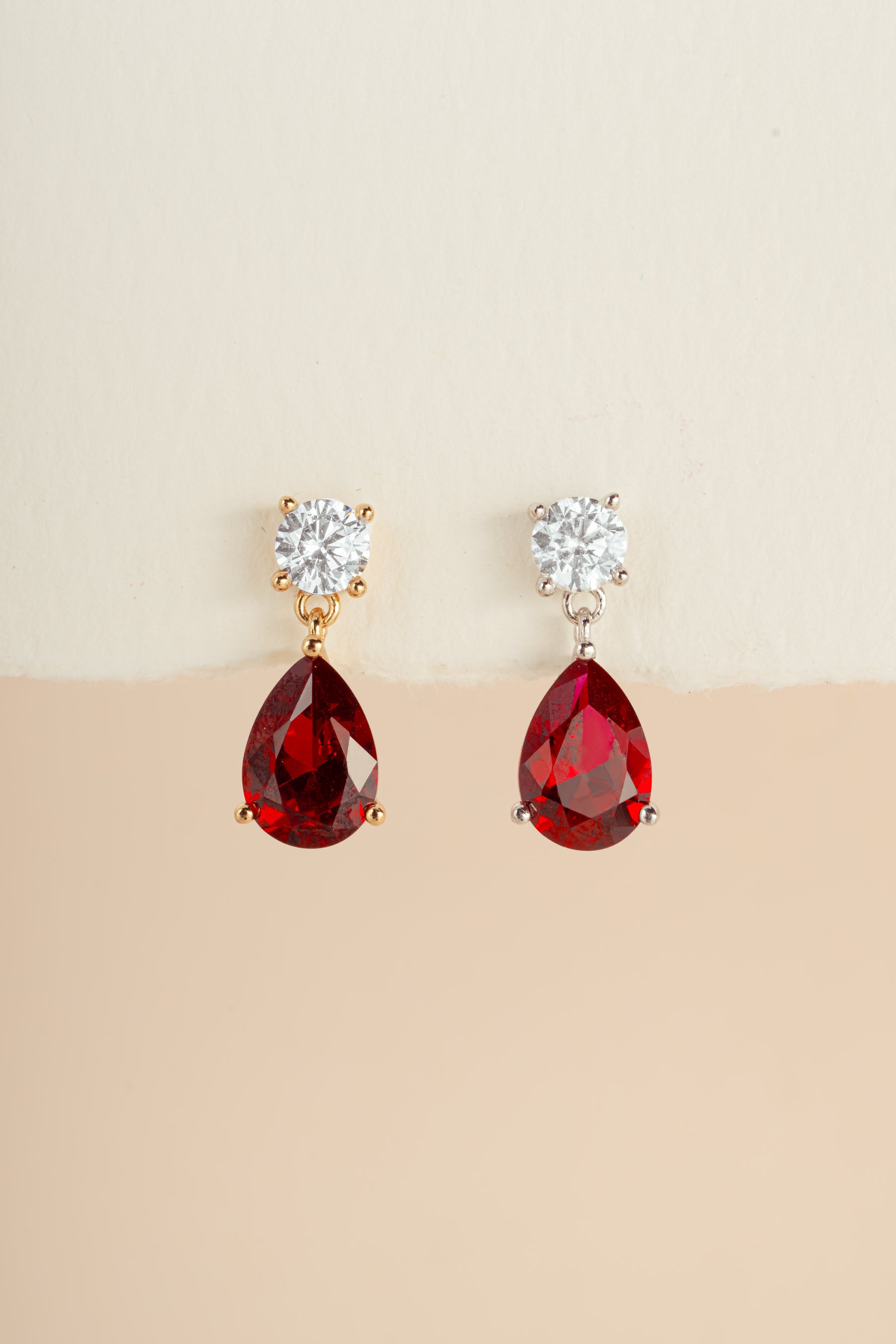 Sami Jewels Camille Ruby Pear Drop Earrings with gold and silver finish, featuring elegant ruby gemstone drops.