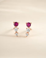 Close-up of Sami Jewels ruby and diamond ear climber earrings in rose gold, showcasing vibrant rubies and sparkling diamonds.