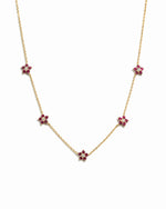 Gold Ruby Flower Necklace by Sami Jewels featuring a vibrant ruby flower charm on a delicate chain.