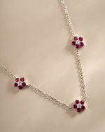 Close-up of Sami Jewels Ruby Flower Necklace featuring a sterling silver chain and a detailed ruby flower pendant.