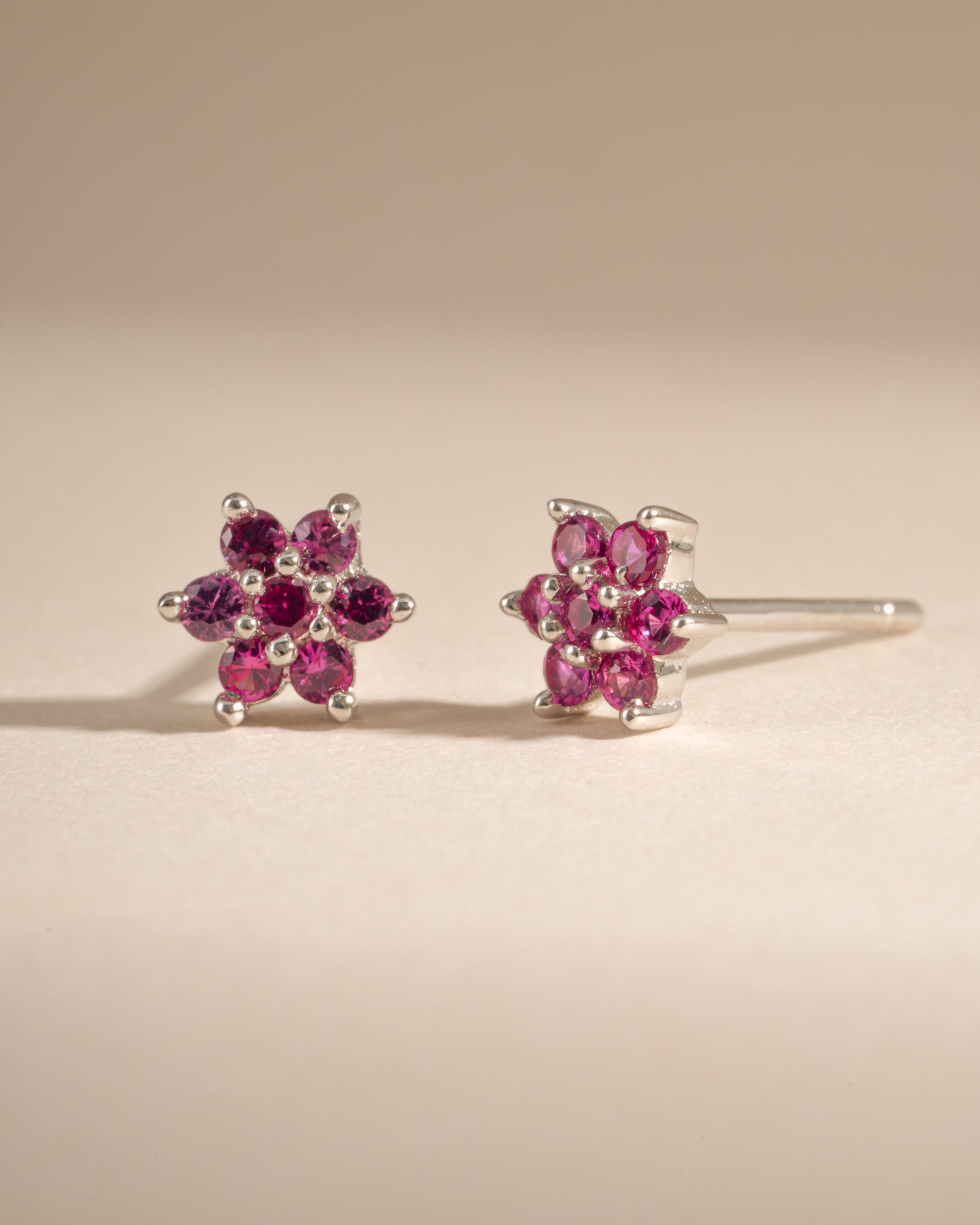 Sterling silver ruby flower stud earrings from Samijewels-527 featuring vibrant red gemstone floral design.