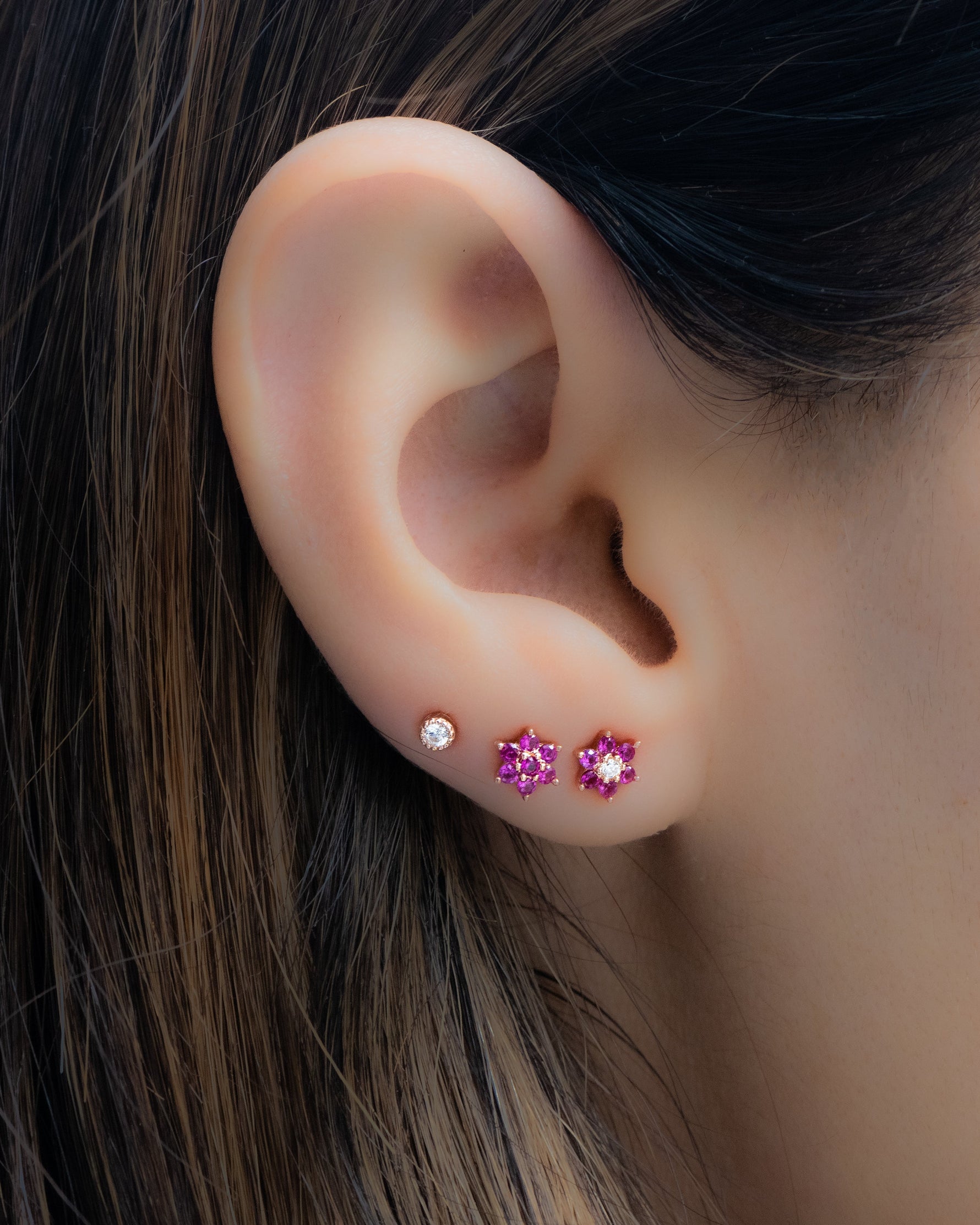 Gold-tone Ruby Flower Stud Earrings by Samijewels-527 featuring vibrant ruby flower designs on classic studs.