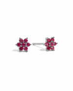 Sterling silver Ruby Flower Stud Earrings with vibrant red gemstones on a white background.