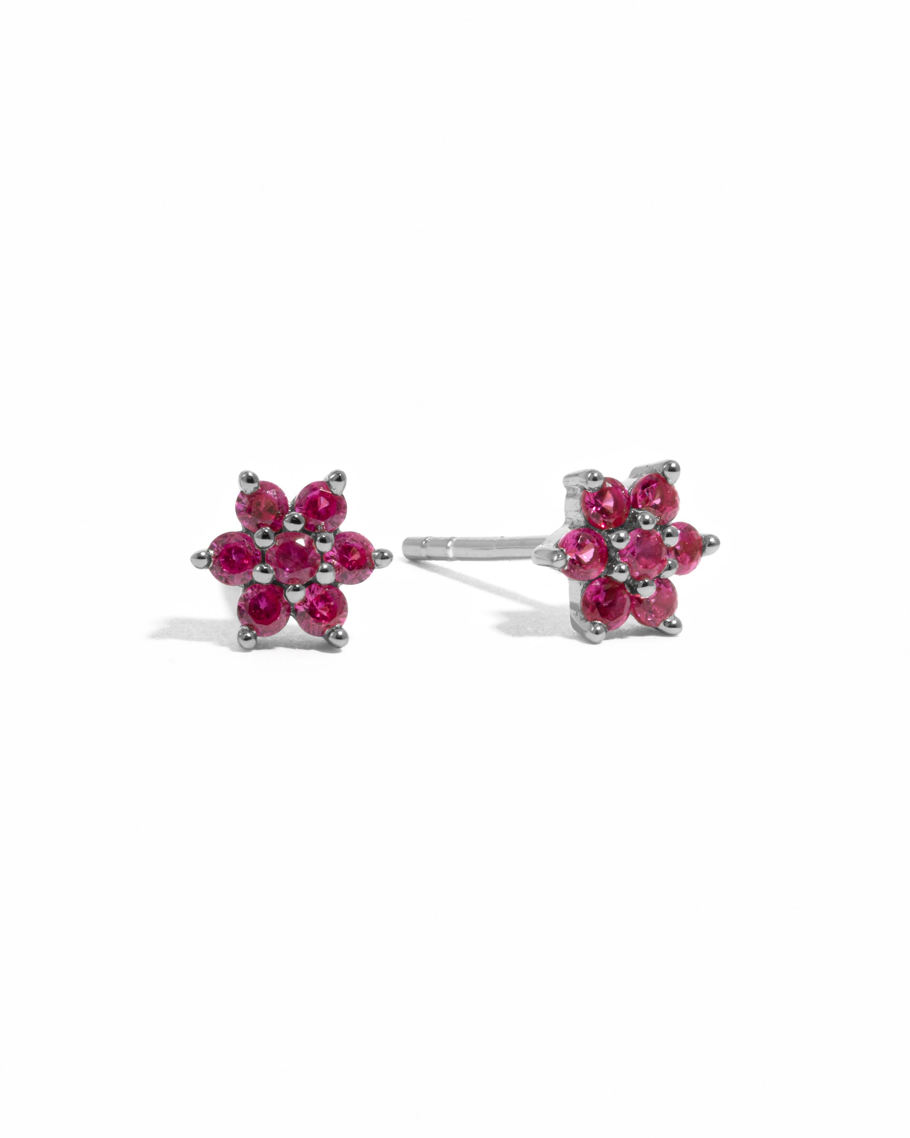 Sterling silver Ruby Flower Stud Earrings with vibrant red gemstones on a white background.