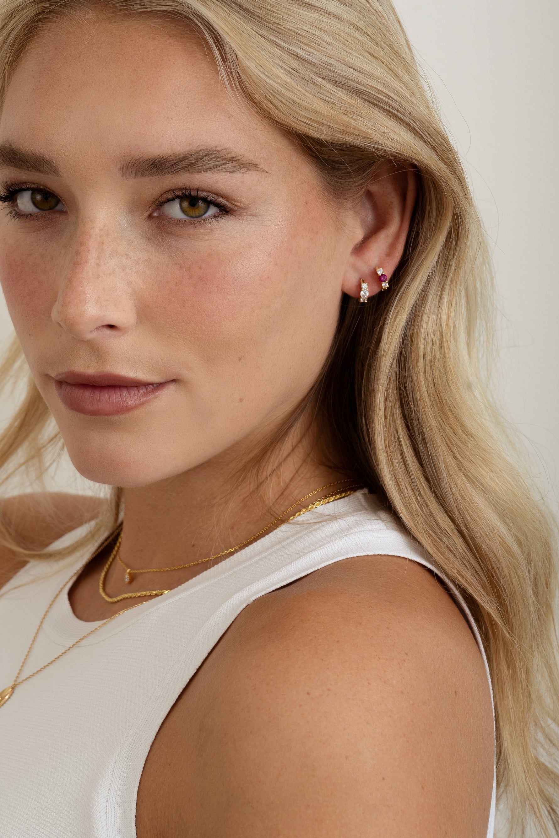 ruby three stone huggie earring on model 