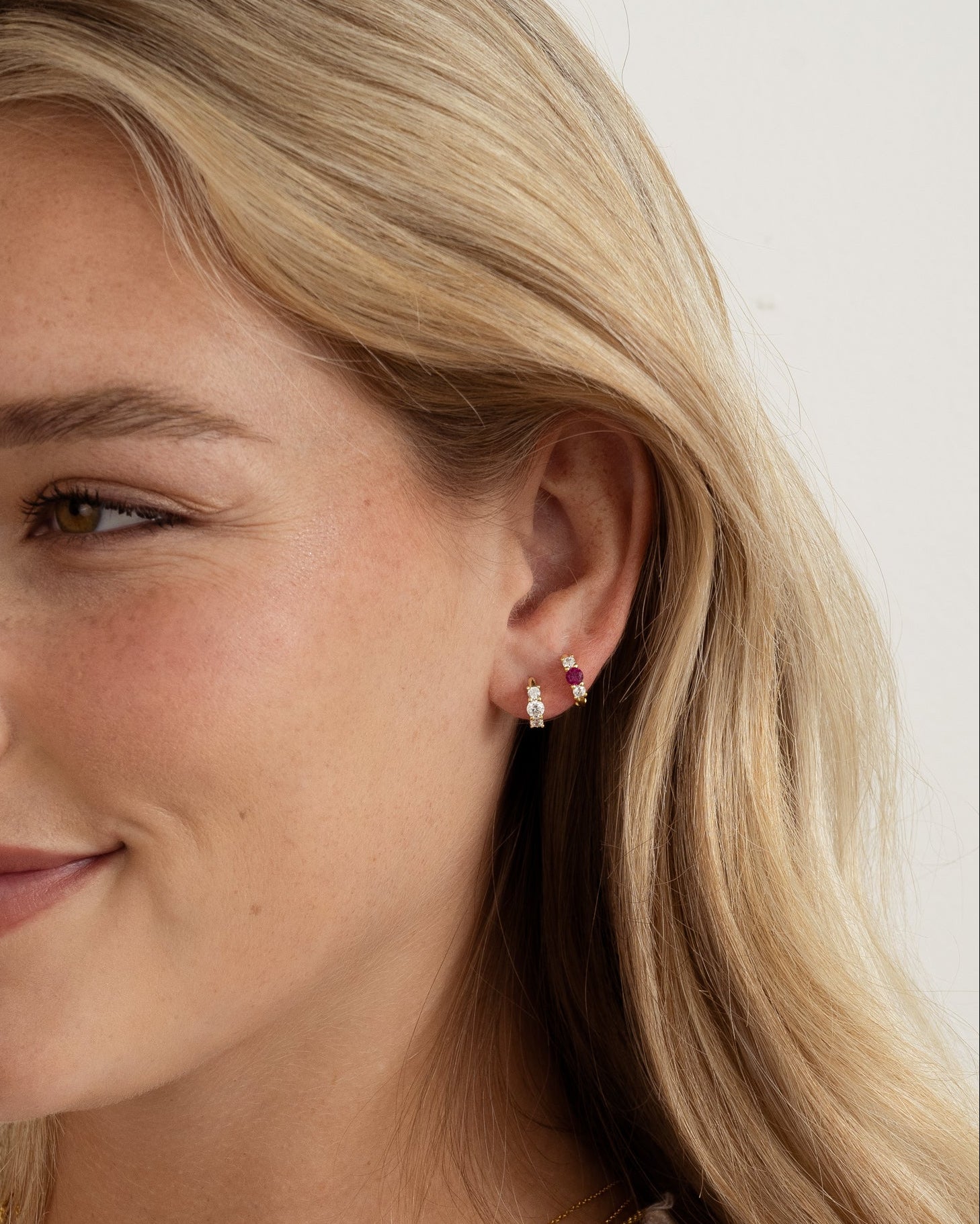 ruby three stone huggie earring stack on model