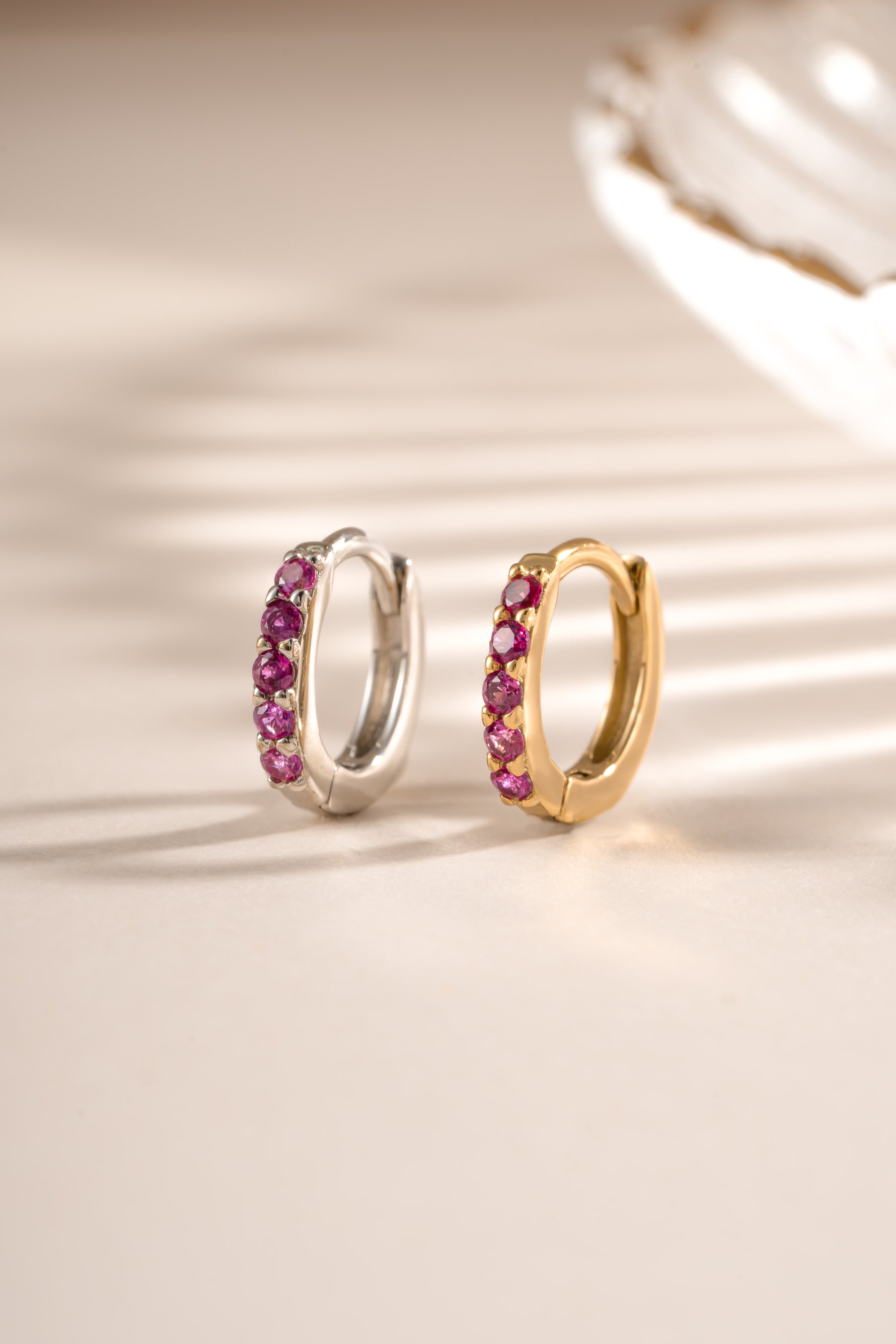 Gold and sterling silver 7mm Ruby Huggie Earrings with sparkling ruby stones from Sami Jewels.