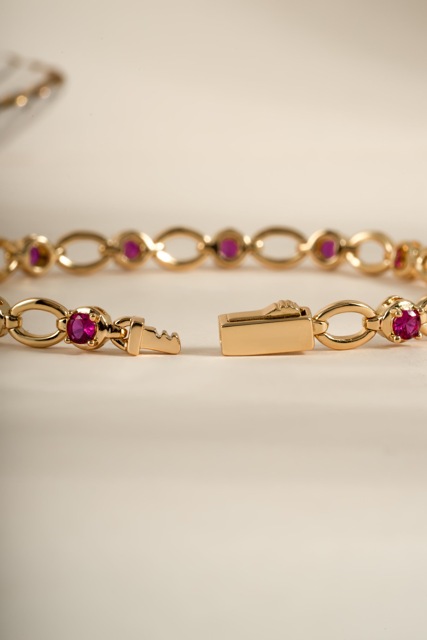 Gold Ruby Lilly Tennis Bracelet by Sami Jewels with a box clasp, featuring vibrant rubies and a sleek bracelet design.