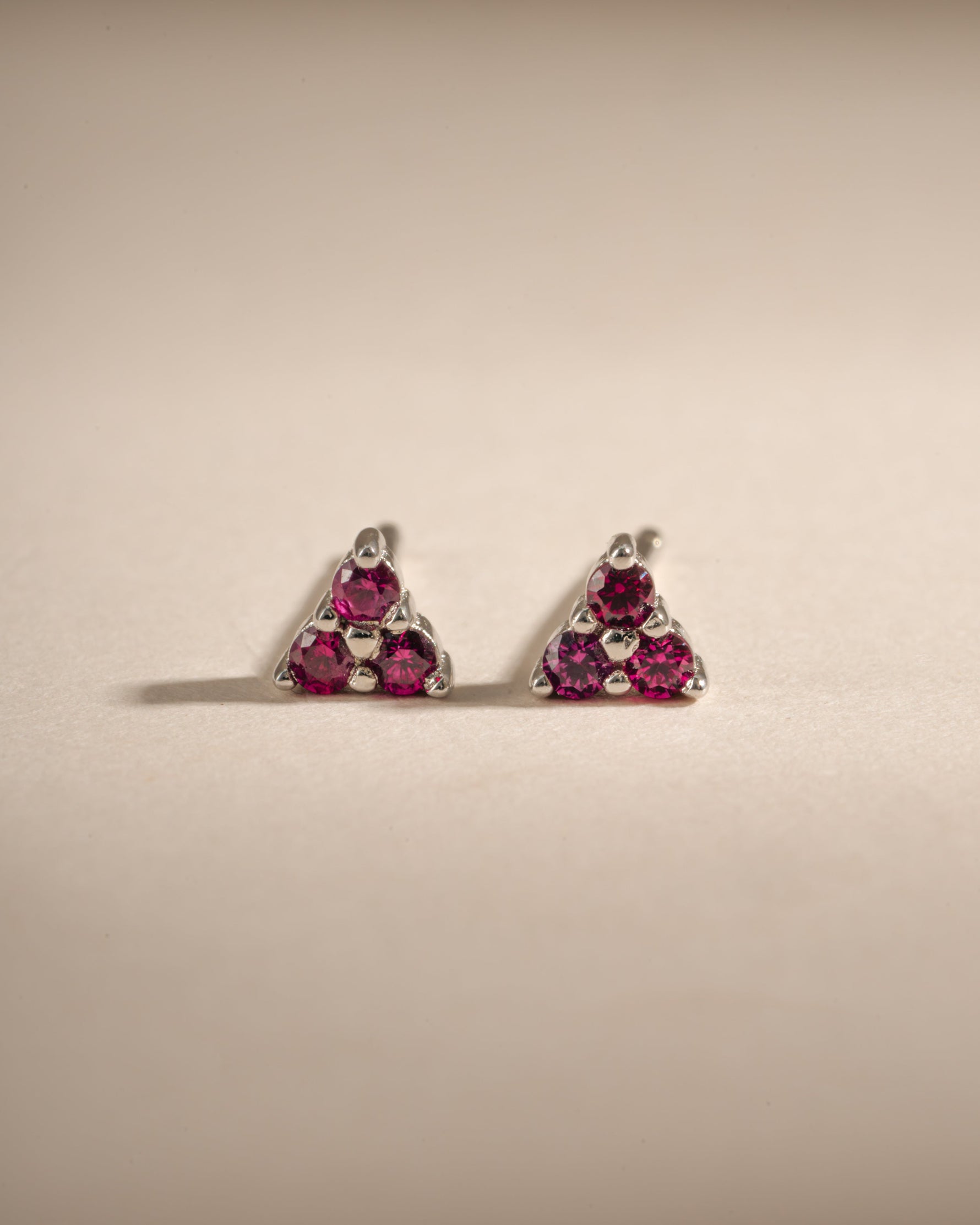 Sterling silver Tiny Ruby 3 Stone Stud Earrings by Sami Jewels with three vibrant rubies in a classic stud design.