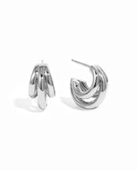 Silver triple hoop earrings on a white background