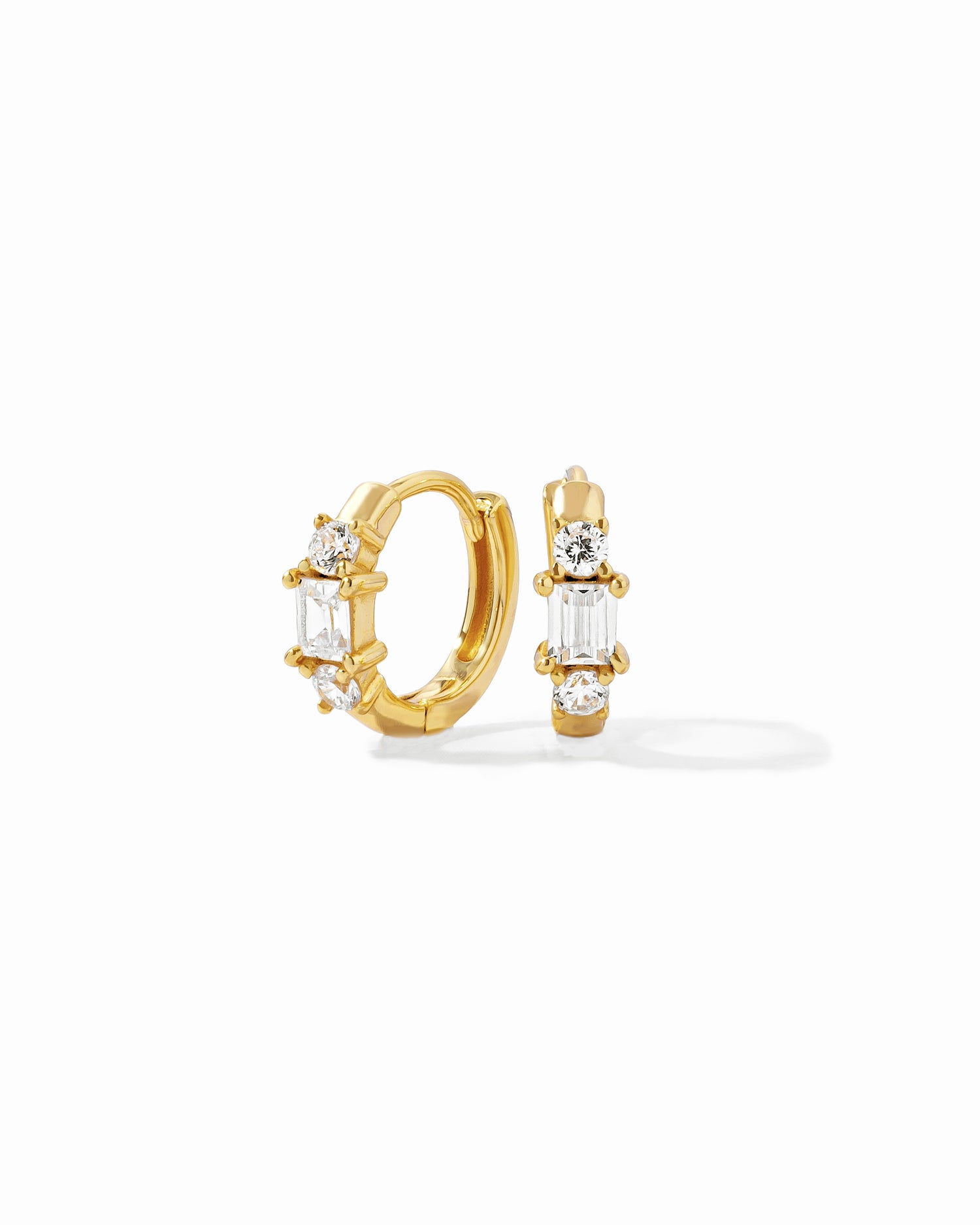 closeup image of gold three stone huggie hoop earring