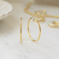 Closeup image of dainty minimalist hoop earrings