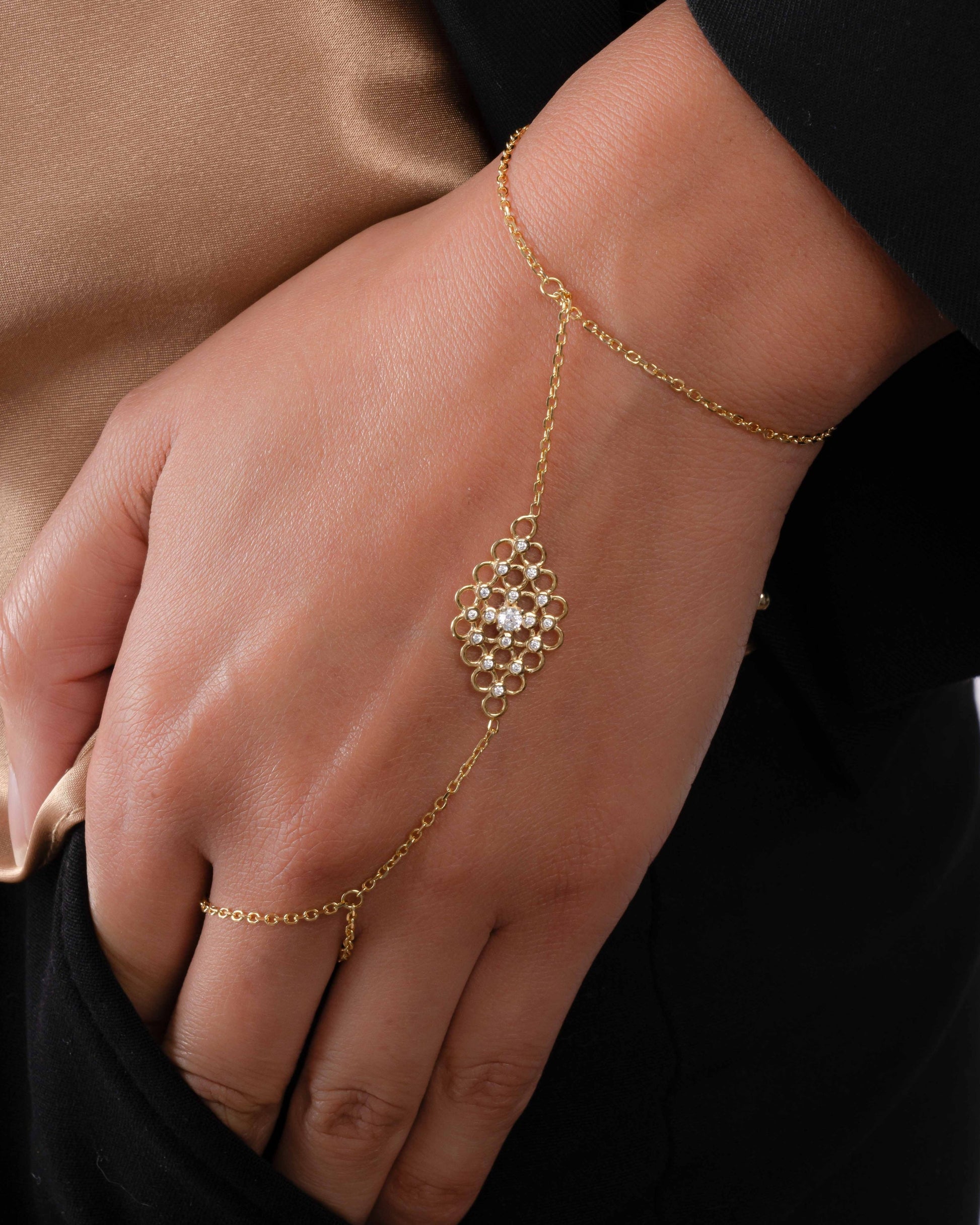 model wearing gold adjustable hand chain bracelet