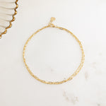 Closeup image of gold minimalist anklets