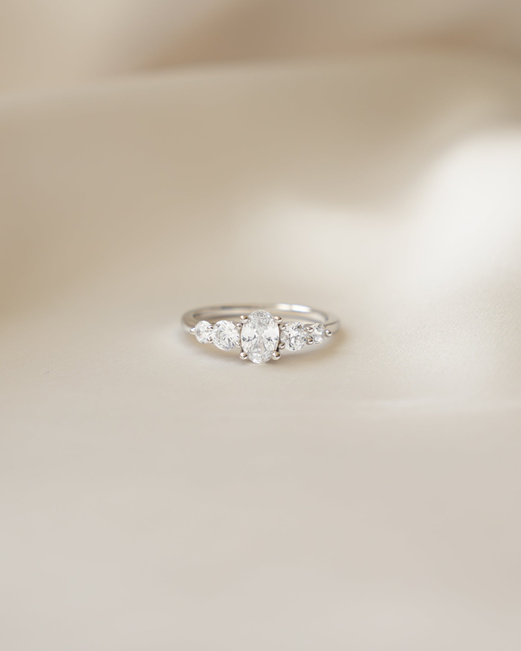 Sterling silver diamond ring on silk background 