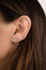Sami Jewels aquamarine diamond bezel dome stud earrings showcasing a polished gemstone set in a gold bezel setting.